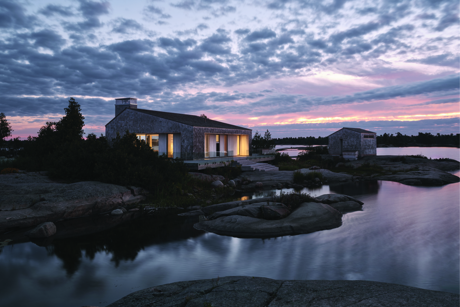 exterior image of whistling wind island cottage as the sun sets